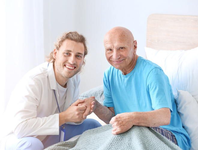 caregiver and elder man smiling
