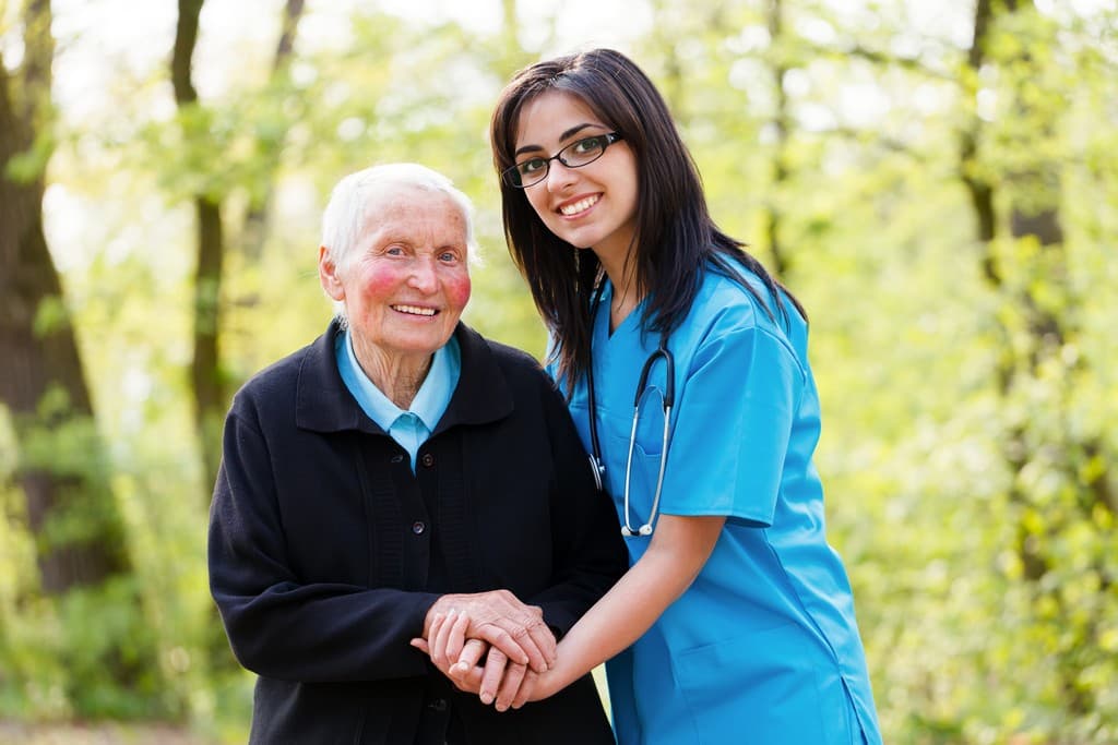 elderly woman and caregiver smiling